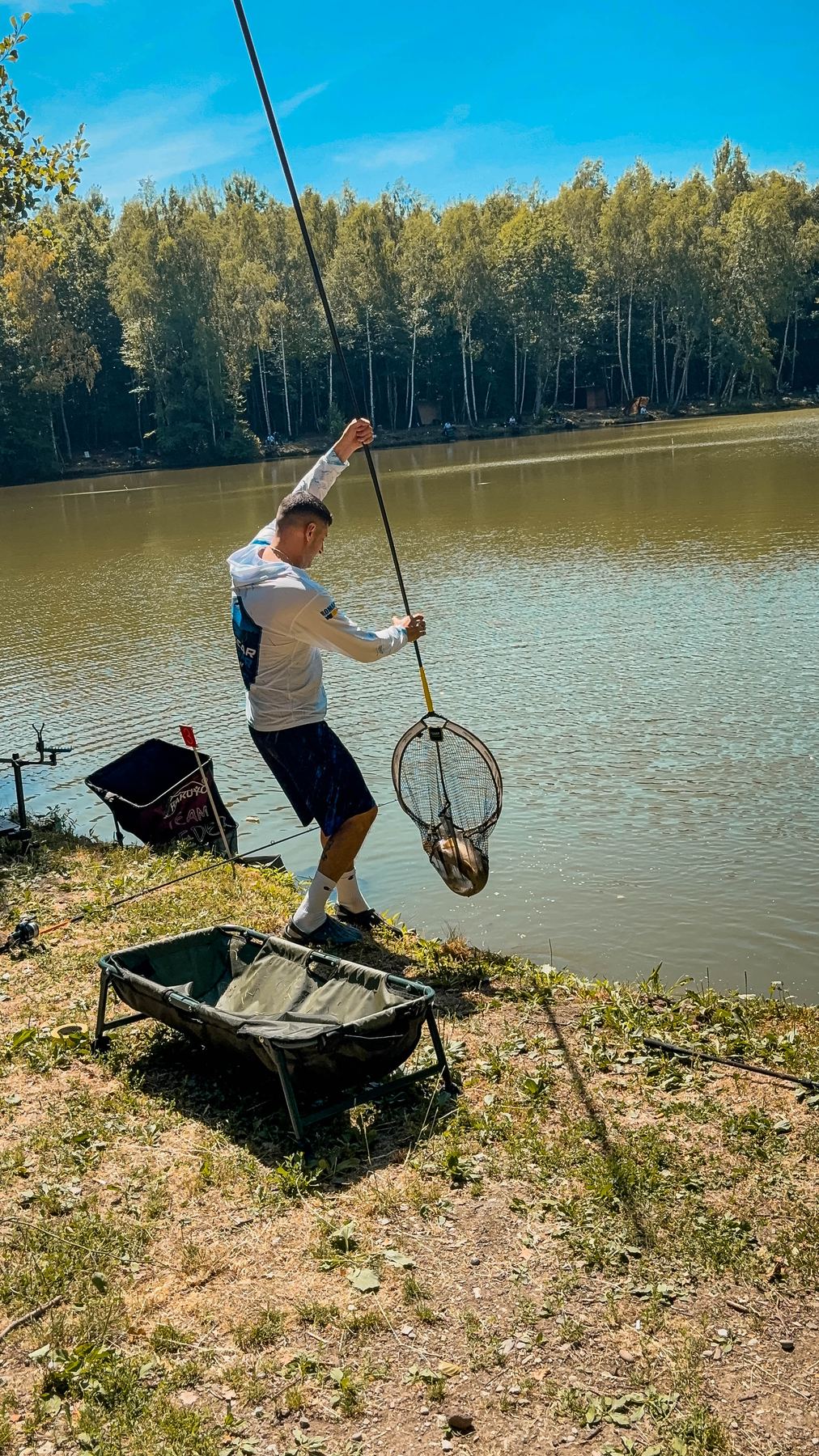 Pescar din echipa Pescar Fugar Team netuind o captură pe malul bălții